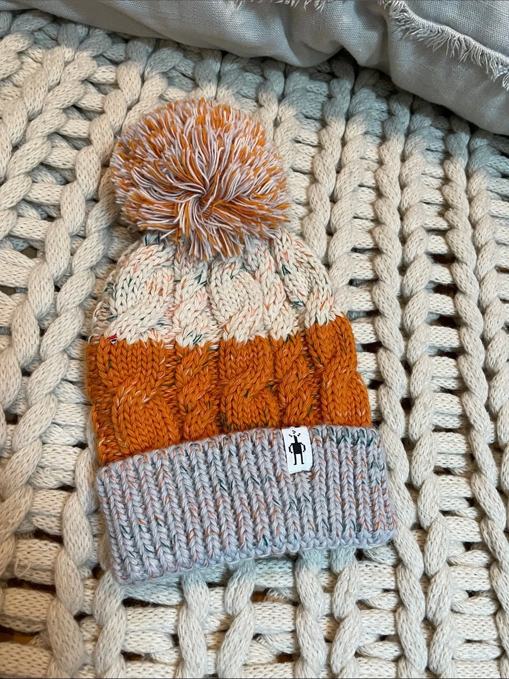 Smartwool Kids Isto Retro Cable Knit Pom Beanie in Orange and Cream and Gray